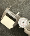 Six Inch Dial Caliper With Dual Metric And SAE Readout, Pro Grade Precision 0.001 Inch Resolution measuring object, focus on dial.