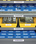 Organized storage shelves with labeled bins showcasing electrical components and metal parts, using Rhino 4200 Industrial Label Maker.