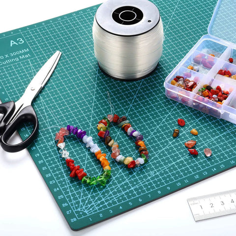 Creating DIY jewelry with Clear Picture Hanging Wire Up To 100 Lbs 656 Feet Monofilament Fishing Line and colorful beads on a mat.