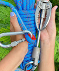 Hands holding Survival Grappling Hook With 32ft Rope Four Claw Foldable Stainless Steel Compact Heavy Duty Tool for outdoor use