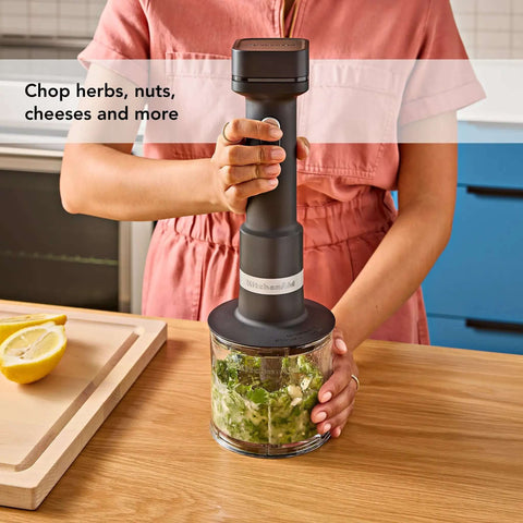 Wireless Stick Blender Set With Whisk No Cords Attached 7 Inch Blending Arm Stainless Steel Blade For Smoothies Soups And Milkshakes Battery Sold Separate Hands Down Best Kitchen Helper in use chopping herbs.
