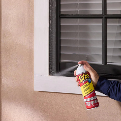 Applying White 14 Oz Waterproof Rubber Spray On Sealant Coating That Stops Leaks Instantly Flexible After Drying Ideal For Gutters Wood RVs Campers Roofs Skylights Windows And More on window frame