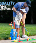 Child practicing with Fun Tot Golf Set For Kids With 4 Lightweight Clubs, 6 Soft Balls, and Mini Putting Mat in yard.