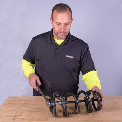 Mechanic using Coil Spring Compressor Tool For Cars And Trucks Easy Removal And Installation Built In Locking Detent Latches