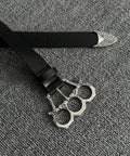 Adjustable Gothic Industrial Belt With Heavy Duty Engraved Knuckle Metal Buckle For Men And Women Punk Rock Fashion Strap on textured background.