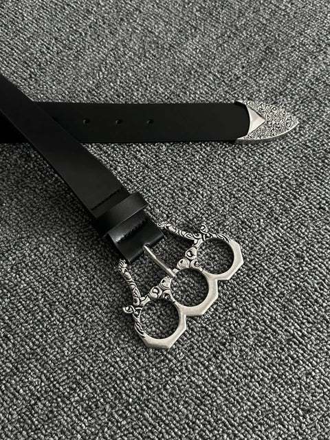 Adjustable Gothic Industrial Belt With Heavy Duty Engraved Knuckle Metal Buckle For Men And Women Punk Rock Fashion Strap on textured background.