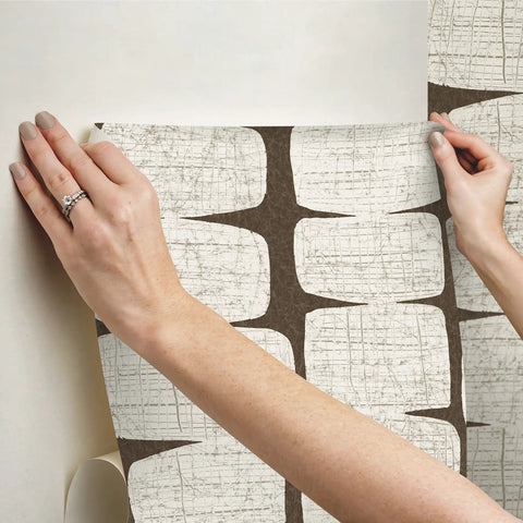 Hands applying Mid Century Beads Peel And Stick Wallpaper Brown No Mess Easy To Install Repositionable And Removable 20.5 Inch