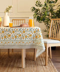 Top Tier Floral Block Print Cotton Tablecloth Yellow Rectangular Dining Cover Washable Farmhouse Kitchen Linen on a wooden table.