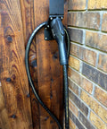 Tough As Nails EV Charger Cable Protector Featuring Flexible Wire Sleeve And Anti Wear Guard Designed For 7/8 Inch Cables mounted on wall.