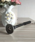 36 Inch Telescoping Magnetic Pickup Tool Heavy Duty Retractable Magnet Stick Lift Up To 30 Lbs next to a decorative vase