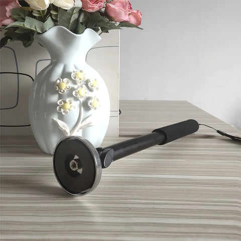 36 Inch Telescoping Magnetic Pickup Tool Heavy Duty Retractable Magnet Stick Lift Up To 30 Lbs next to a decorative vase