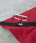 Self Tapping Ice Shelter Anchors Stainless Steel Screw In Two Pack securing a red ice tent on an icy surface