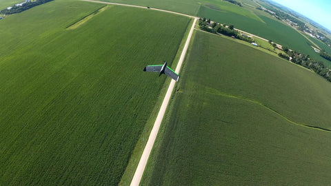 Double 4K Fixed Wing Drone With 1 Hour Flight Time And 35 MPH Cruise Long Range Omnidirectional Link flying over farmland