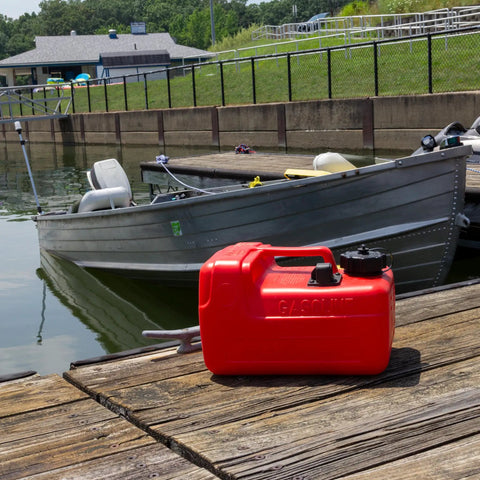 Three Point Two Gallon Portable Boat Fuel Tank With 2 Way Vented Cap Built In Fuel Gauge on a dock near a small boat