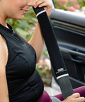 Go-To Universal Fit Waterproof Car Seat Cover With Neoprene shown on a car seat with woman adjusting seat belt cover
