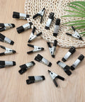 20 Pack Small Clamps For Garden And Crafts, Mini Heavy Duty Spring Clamps With Three Quarter Inch Jaw Opening on table