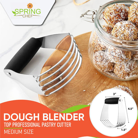 Pro Grade Dough Blender For Cutting Cold Butter Into Flour Like A Kitchen Boss With Heavy Duty Stainless Steel Blades Ideal For Pastry And Bread Dough Medium Size Black Kitchen Tool on a wooden board next to a glass jar of treats.