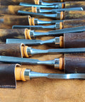 Close-up of chisels in Heavy Duty Tool Roll Up Pouch With 12 Slots Portable Leather Tool Carry Bag Vintage Handmade Wrench Roll Chisel Organizer Full Grain Leather Craft Built For DIYers And Pros.