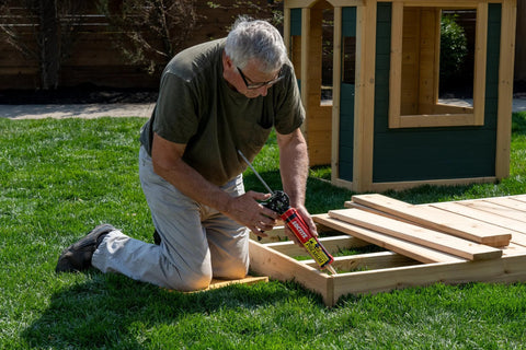Loctite PL Premium polyurethane construction adhesive tube applied to wooden framing outdoors