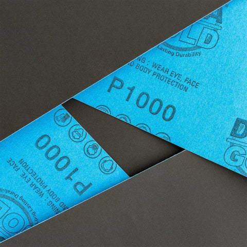 Pro-Grade 1000 Grit Wet Or Dry Sandpaper Sheets 5-1/2 X 9 In Box Of 25, blue sheets showing P1000 labels.