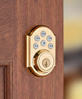 SmartCode 910 Z Wave Plus Deadbolt With Keyless Entry And Illuminated Keypad, Polished Brass Finish on wooden door