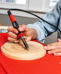 Person using Wood Burning Kit 25W 120V Eight Piece Set With Stay Cool Handle for precise pyrography on wooden surface