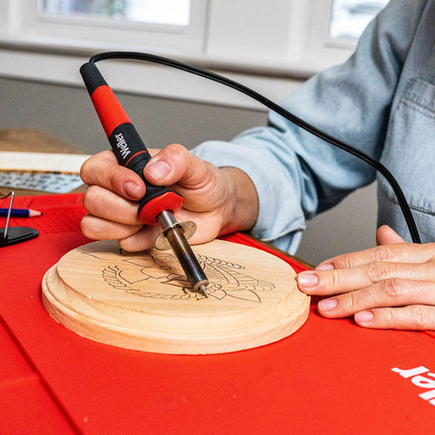 Person using 15 Piece Woodburning Kit 25W 120V With Stay-Cool Handle, Precision Tips for DIY wood project on round wood piece