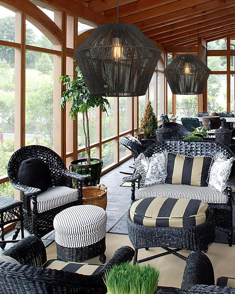 7 Inch Handwoven Rattan Pendant Light With Matte Black Basket Shade in modern boho seating area, featuring wicker chairs