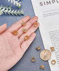 Golden Crown Beads Set 11x7mm Large Hole Crystal Cubic Zirconia Pave King Crown Charms displayed on a hand and surface.