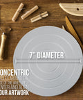 7-inch diameter metal sculpting wheel on wooden work surface with clay sculpting tools nearby