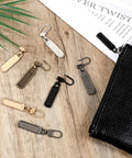 10 Piece Zipper Pull Replacement Set Silver Black Gold Copper for jackets bags luggage backpacks coats shoes displayed on table