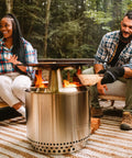 Bonfire Cast Iron Grill Cooking Bundle 2.0 With Smokeless Fire Pit Stand Hub And Removable Ash Pan in use outdoors
