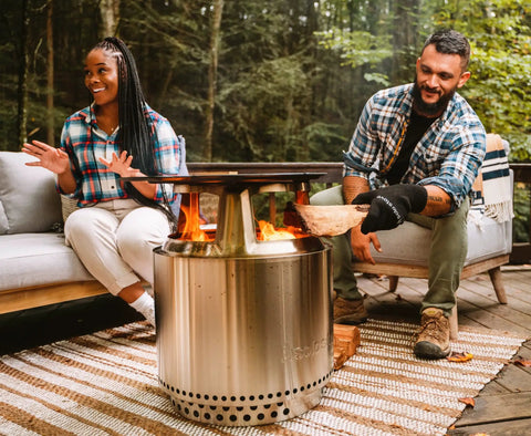 Bonfire Cast Iron Grill Cooking Bundle 2.0 With Smokeless Fire Pit Stand Hub And Removable Ash Pan in use outdoors