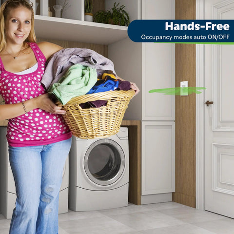 Woman holding laundry in room with Motion Sensor Light Switch With Auto On Auto Off Occupancy Sensor for 150W LED and CFL Lighting, wall switch visible.