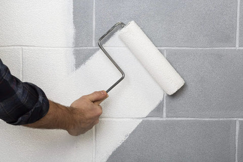 Applying All Purpose Primer Sealer Stain Killer For Interior And Exterior Surfaces Bonds To Glossy Finishes Works At 35 F Rust Inhibitive Stain Blocking Ideal For Ferrous Metal Seals And Preps Quickly 1 Quart to concrete wall with paint roller.