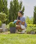 Person using Cordless Hedge Trimmer And Grass Shears For Easy Lawn Edges And Shrubs Battery Powered Handheld Electric Garden Tool.