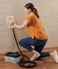 Woman using Chemical Free Wallpaper Steamer For Easy Peasy Removal, No Harsh Chemicals, Dual Steam Plates Included on wall