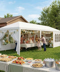 Heavy Duty Outdoor Party Tent 10x30 Gazebo With Removable Sidewalls set up for a backyard party, with family celebrating under the tent.