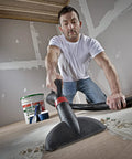 Man using vacuum to clean drywall dust with high efficiency disposable filter bags for 15-22 gallon tanks white 2-pack