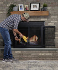 Person using Top Shelf 19 Inch Oversized Fire Bellows Hand Carved From Dense Oak Wood With Genuine Leather Accents and Rustic Studs.