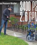 Powerful Gas Pressure Washer 3400 PSI, 2.6 GPM in use on a driveway with a spray gun and wand, home exterior in background