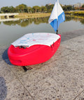 Spearfishing Float Boat With Carry Straps Foldable Flagpole And Compact Storage Red Buoy lakeside view
