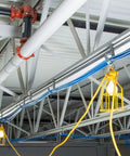Industrial ceiling with hanging lights powered by Extra Heavy Duty Outdoor Triple Tap Extension Cord 100 Foot 12 Gauge 15 Amp 125 Volt Yellow