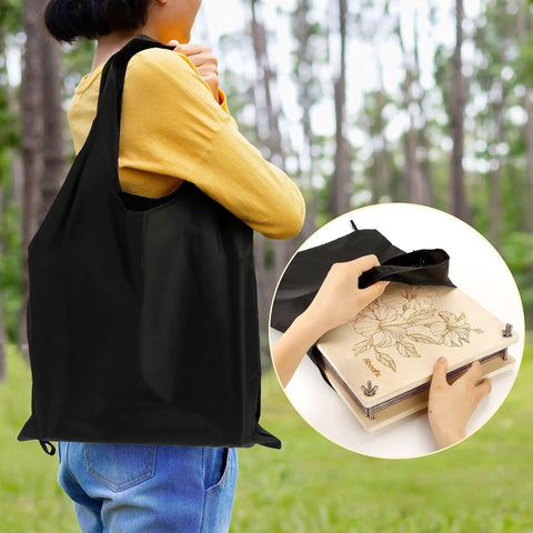 Person holding 11x11 Inch 10 Layer Flower Press Kit for Diy Crafts pressed flowers and plant pressing in black bag outdoors.