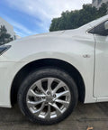 Front view of a white car tire with Glow In The Dark Prank Tire Valve Stem Caps 4 Pack Dust Proof Covers For Cars SUVs Trucks.