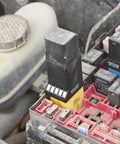Close-up of a Four Piece Relay Test Jumper Kit for Cars and Trucks in use within a vehicle's relay panel.