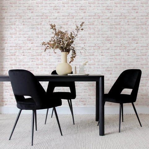 Dining area with black chairs and table against a wall covered with Black Brick Textured Peel And Stick Wallpaper Removable Self Adhesive For Easy Diy Wall Makeovers No Mess No Glue 20.5 Inch By 16.5 Foot Realistic Brick Look Made In USA