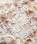 Lit This Is Where The Magic Happens Neon Sign Wall Decor LED 24x20 Inch Warm White Light arranged on a fuzzy surface