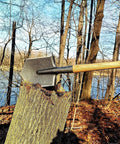 Battle Wolf Military Grade Survival Shovel with carbon steel head and hardwood handle stuck in tree stump