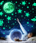 Child reaching for glow-in-the-dark stars and planets ceiling wall decor kit with rockets and astronauts for a galaxy themed kids room